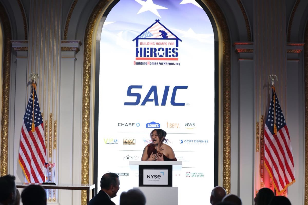Kianni Martinez speaking at the NYSE podium — Building Homes for Heroes Gala